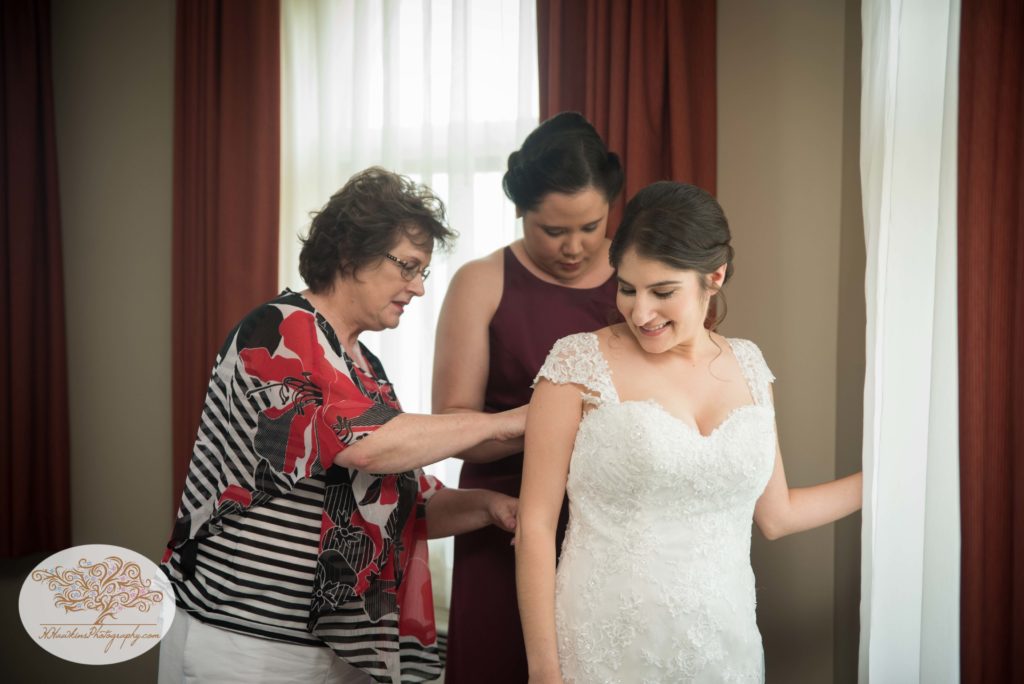 Bride getting into wedding dress