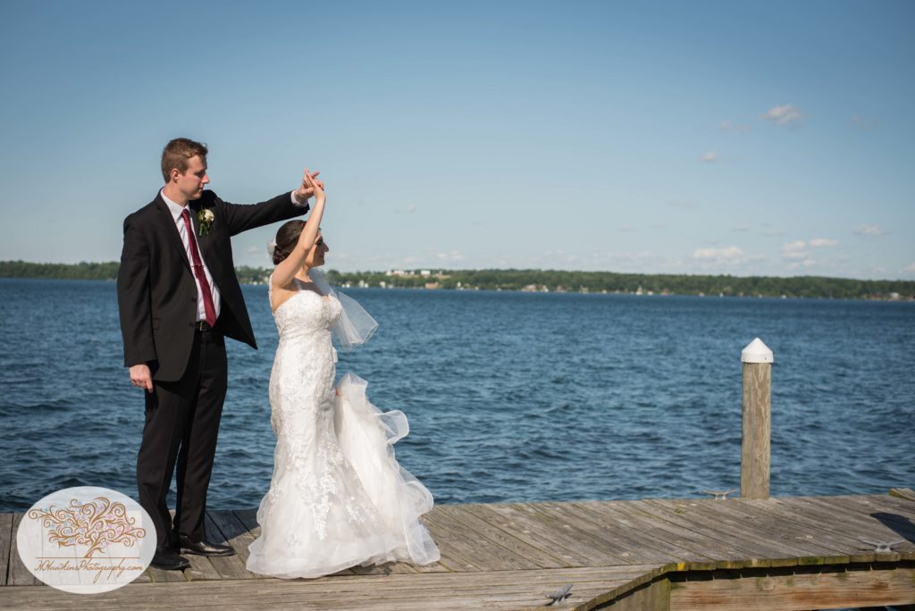Groom spins bride on docks of Belhurst Castle on Seneca Lake Geneva NY