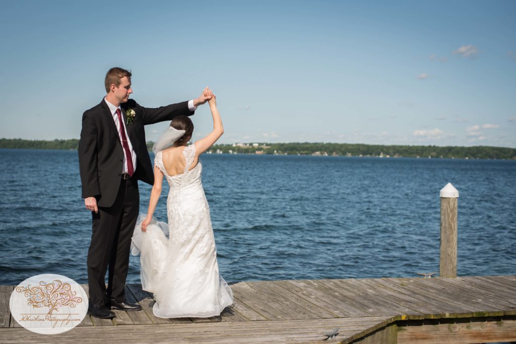 Groom spins bride on docks of Belhurst Castle on Seneca Lake Geneva NY