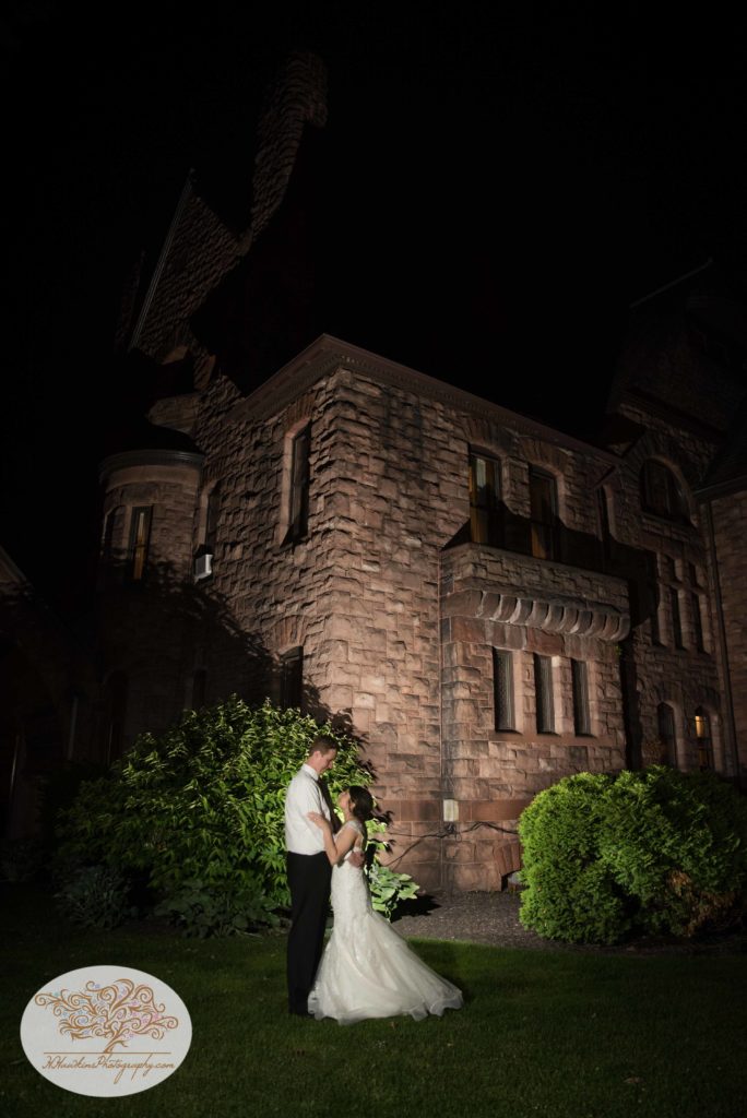 Bride & Groom in front of Belhurst Castle Geneva NY for night time wedding photo