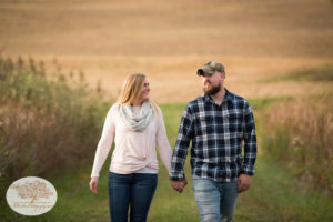 Couple getting married walks hand in hand during engagement session