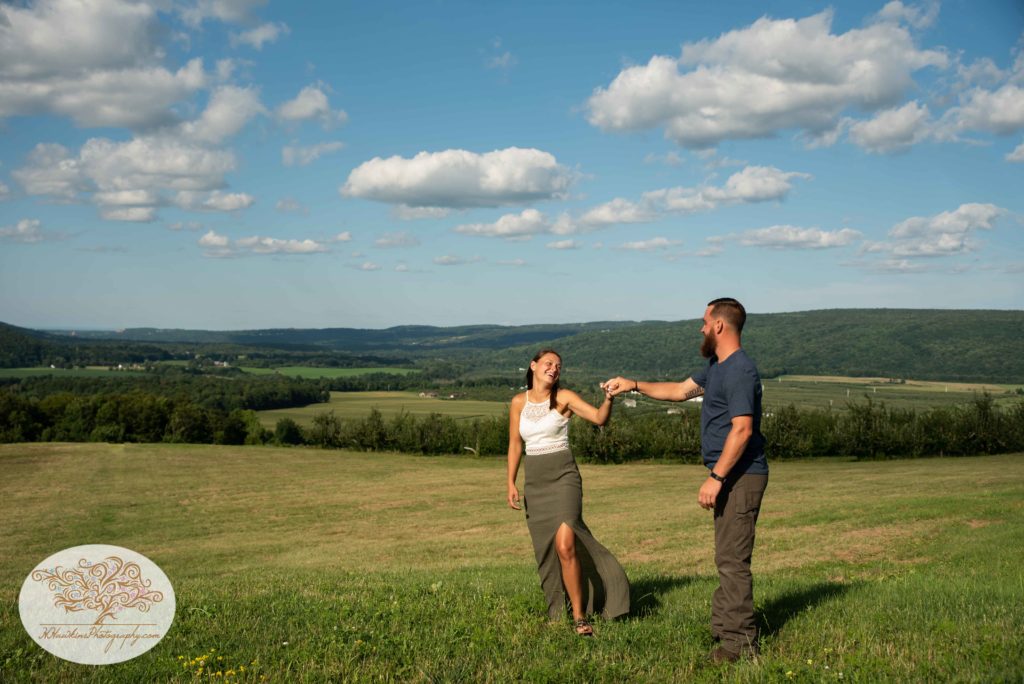 Groom spins bride overlooking the hills of Lafayette NY on Route 20 at Beak and SKiff's Distillery