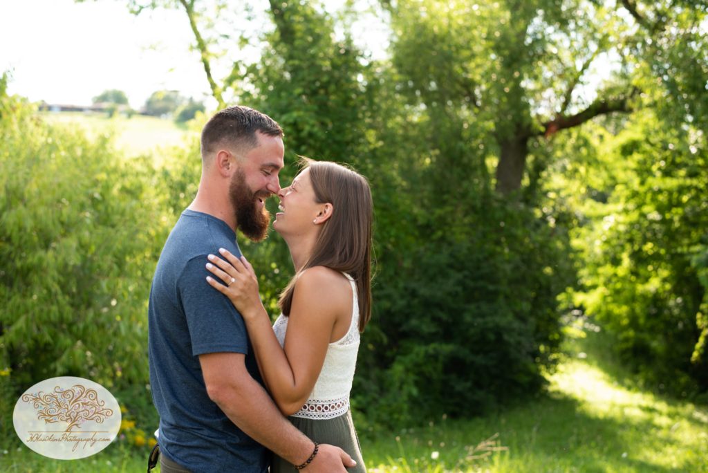 Bride and groom to be give each other an eskimo kiss at Beak and SKiff's apple orchard