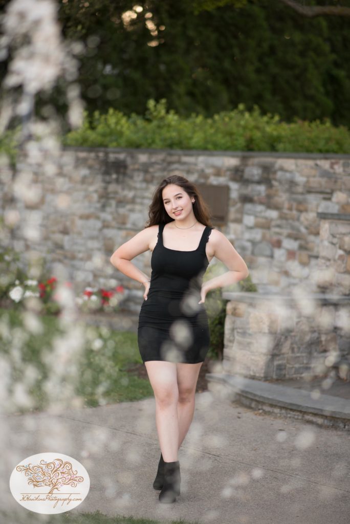 Picture of senior girl standing behind fountain at Clift Park Skaneateles NY
