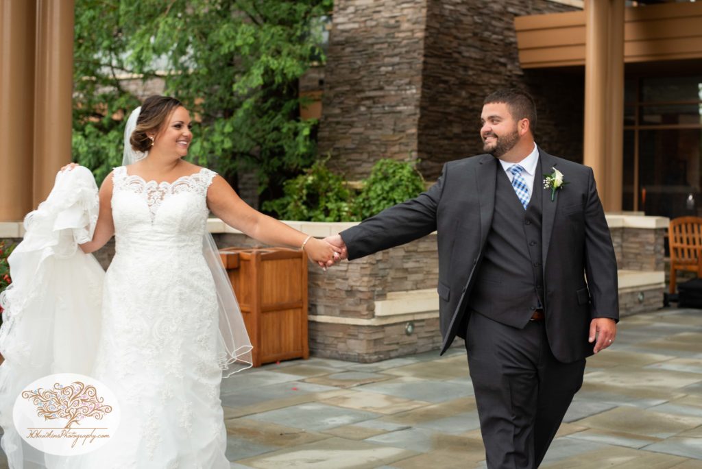 Bride and groom take a walk during their wedding picture time at Turning Stone Resort and Casino in Verona NY