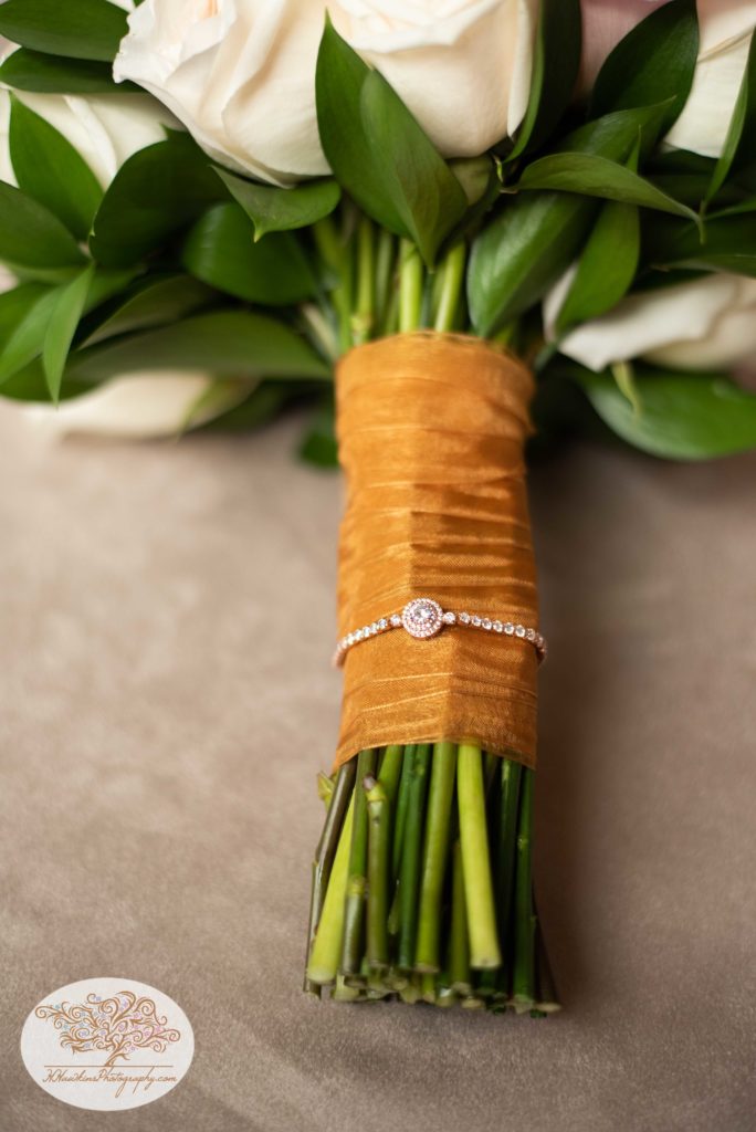 Bride's bouquet of flowers and borrowed bracelet