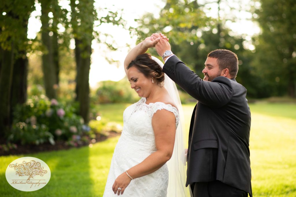Groom spins bride during picture time at Shenendoah Clubhouse at Turning Stone