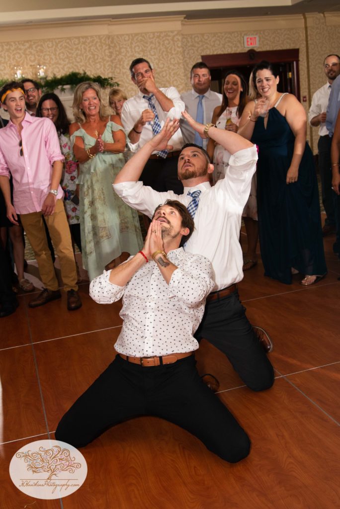 Groomsman and guest dance like crazy at wedding reception at Turning Stone