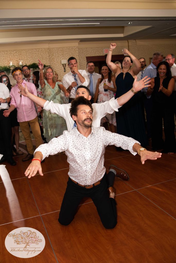 Groomsman and guest dance like crazy at wedding reception at Turning Stone
