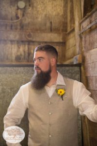 Groom looks into barn in Upstate NY where his wedding is held