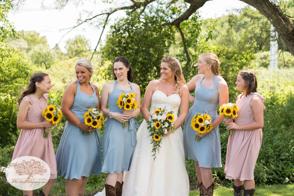 Bridesmaids laugh at each other by Syracuse wedding photographer