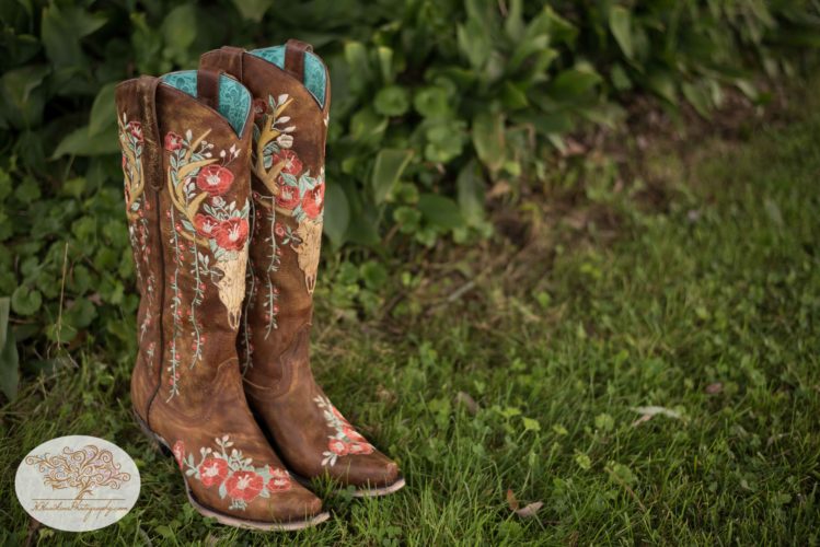 Decorated cowgirl boots for bride at barn wedding
