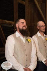 Groom waits for bride to walk down aisle at their Upstate NY barn wedding