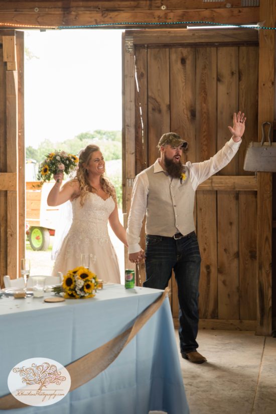 Bride and groom enter reception during Upstate NY barn wedding