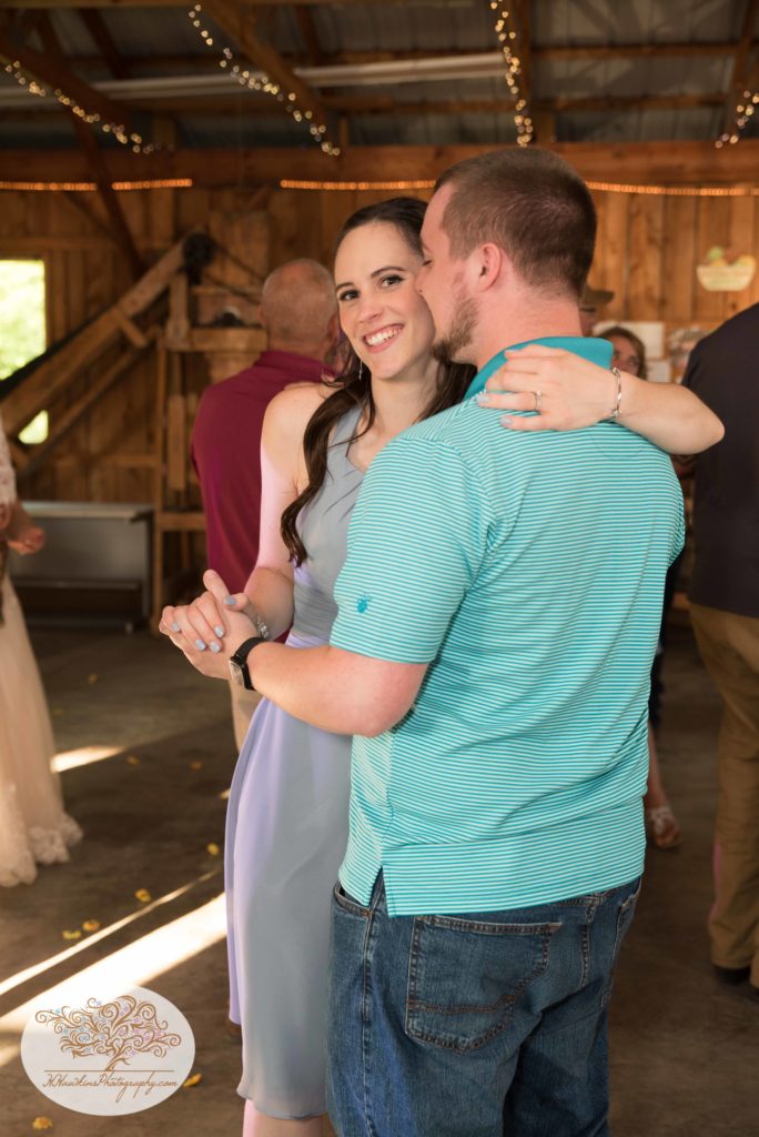 Maid of Honor dances with her fiance at orchard wedding reception