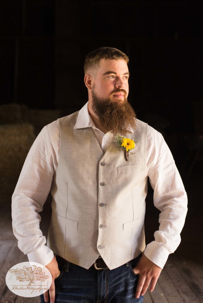 Groom with hands in jeans pocket for upstate NY barn wedding