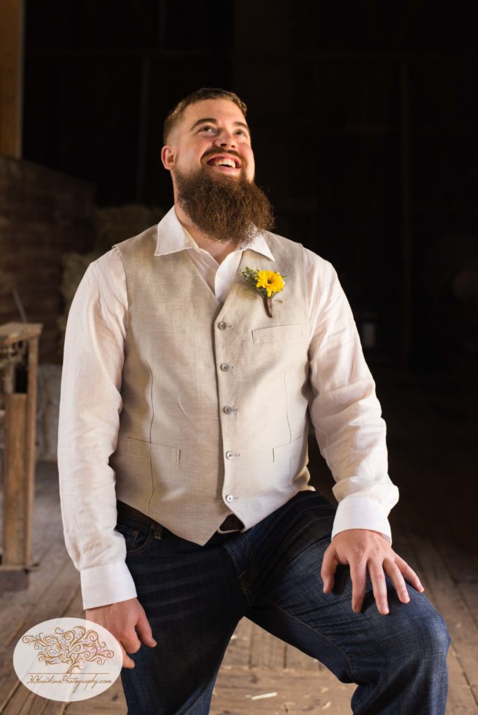 Groom laughs during portrait session by Syracuse photographer