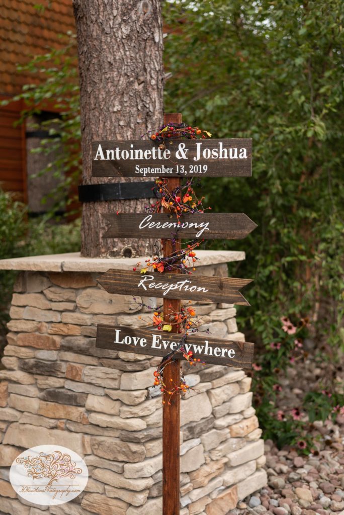 Autumn wedding sign that points out the direction of the ceremony and reception