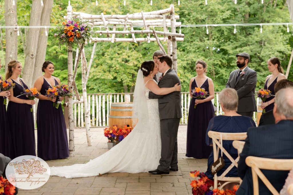 Bride and groom kiss at the altar at Tailwater Lodge's Overlook