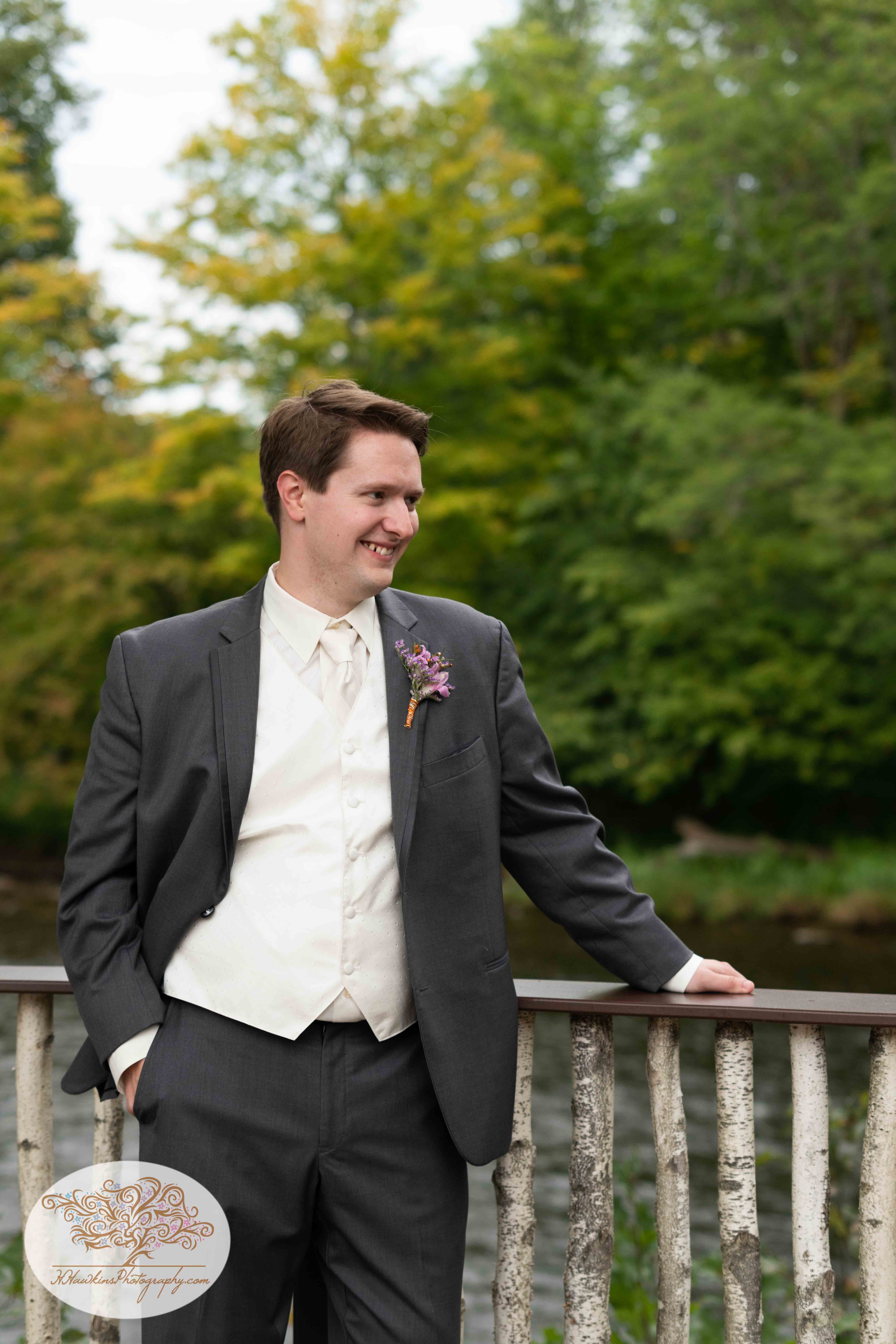 Groom smiles during his portrait session at Tailwater Lodge's Overlook