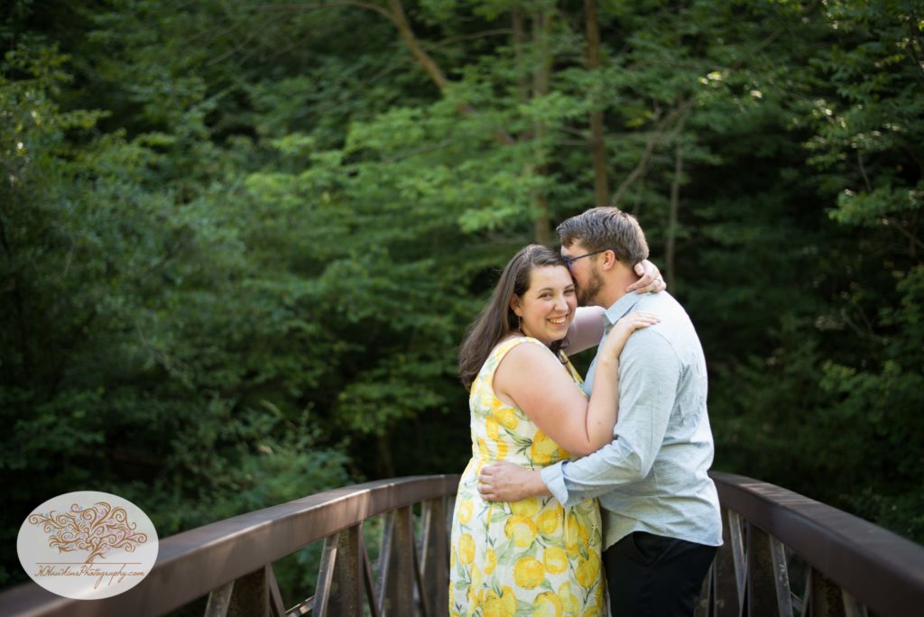 Bride smiles at camera during their engagement photo session