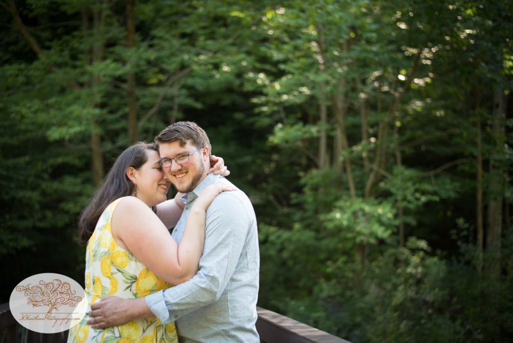 Groom to be smiles at the camera during their engagement session