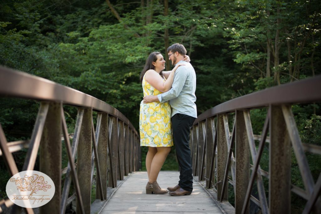 Lines of bridge at Chittenango Falls lead to bride and groom during their engagement session