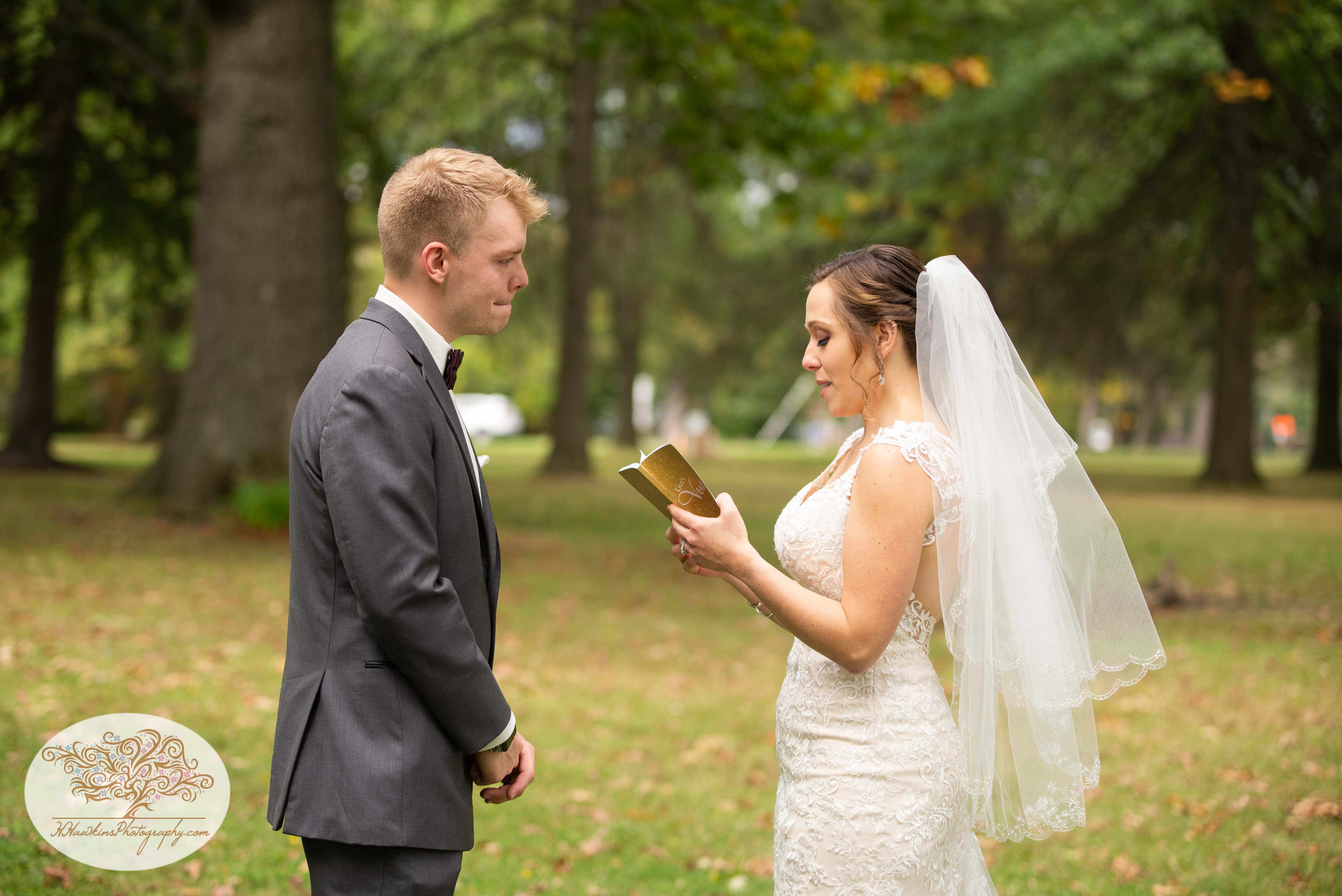 Groom holds back tears as his bride reads her vows to him