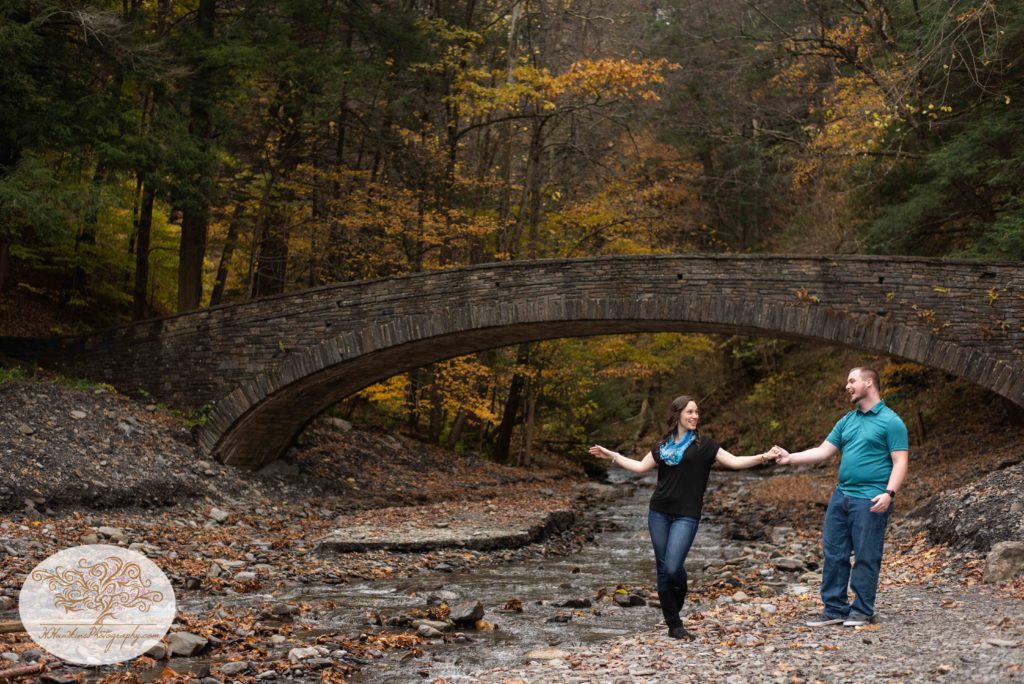 Bride and Groom show off their swing dance moves beside a creek at Fillmore Glen