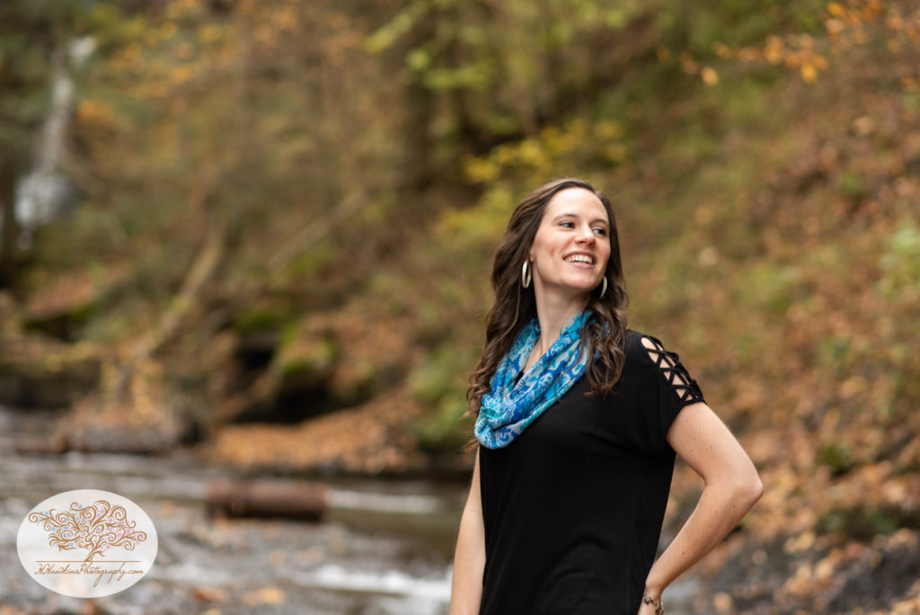 Bride to be looks off to her left during their engagement photos