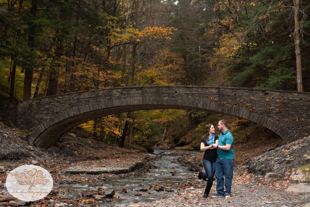 Bride and Groom show off their swing dance moves beside a creek at Fillmore Glen
