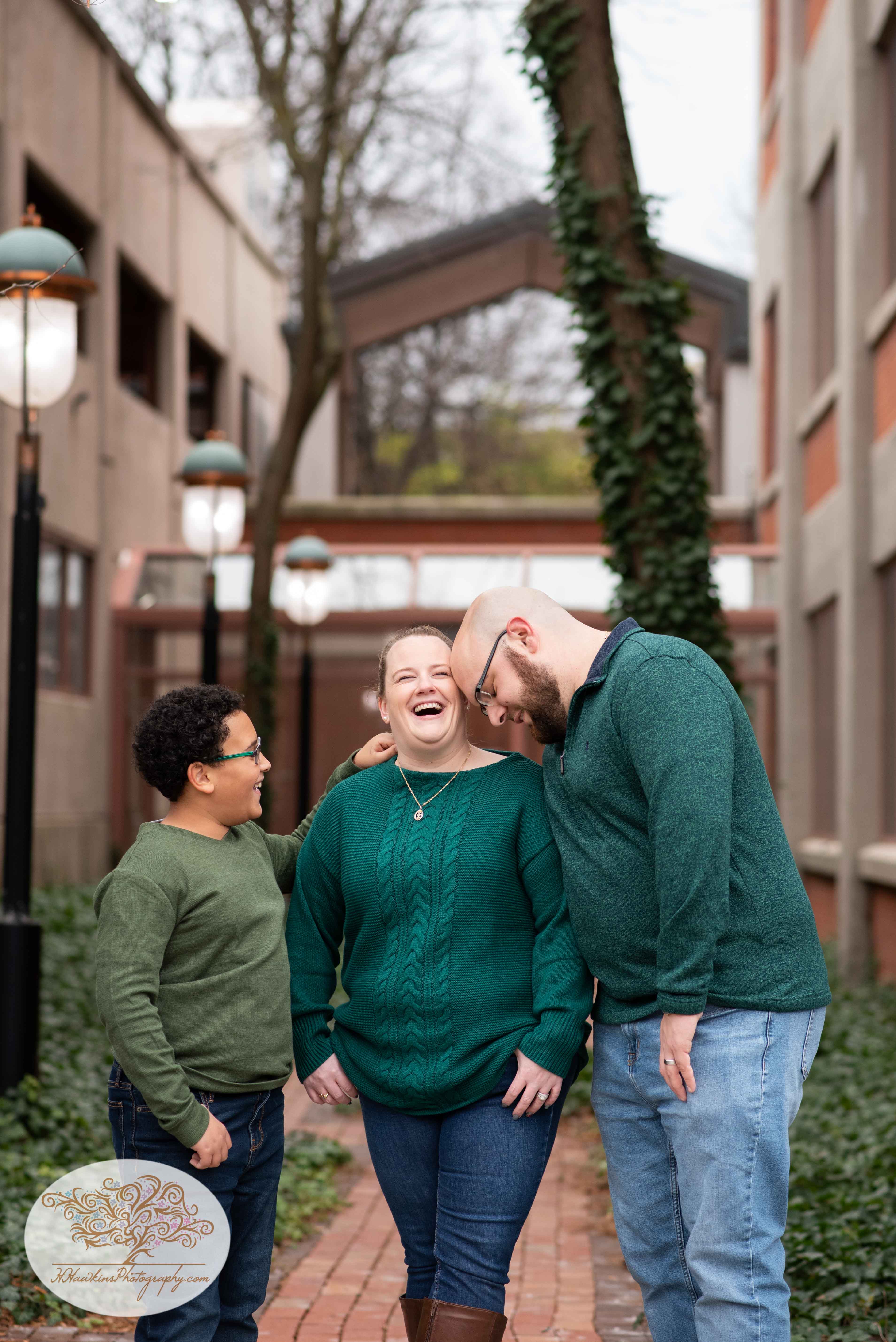 Family of three share a laugh during their family picture session by Syracuse photographer
