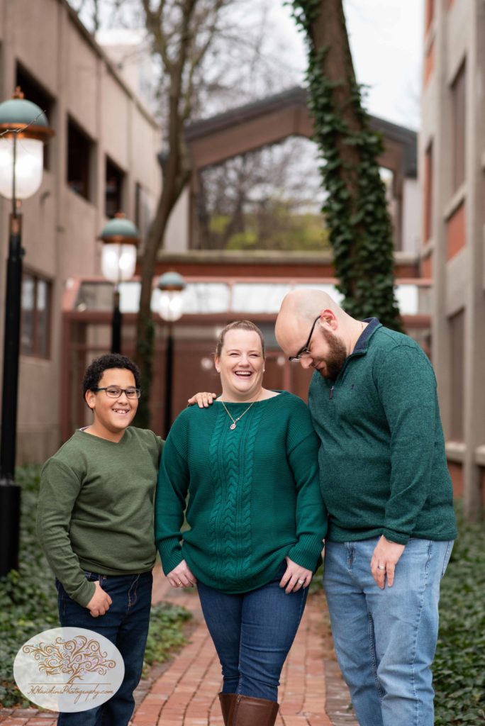 Family of three share a laugh during their family picture session by Syracuse photographer