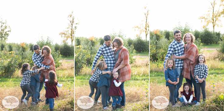 Little girls play tackle their parents during family picture session
