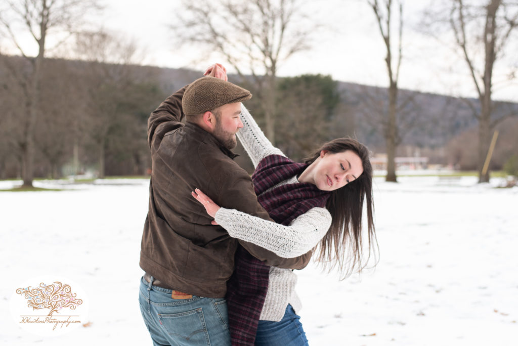 bride and groom ball room dance during their snowy engagement session