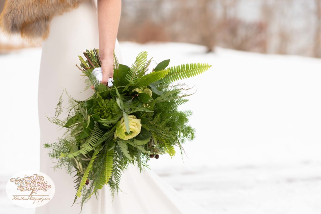Brides green bouquet arranged with ferns and white roses