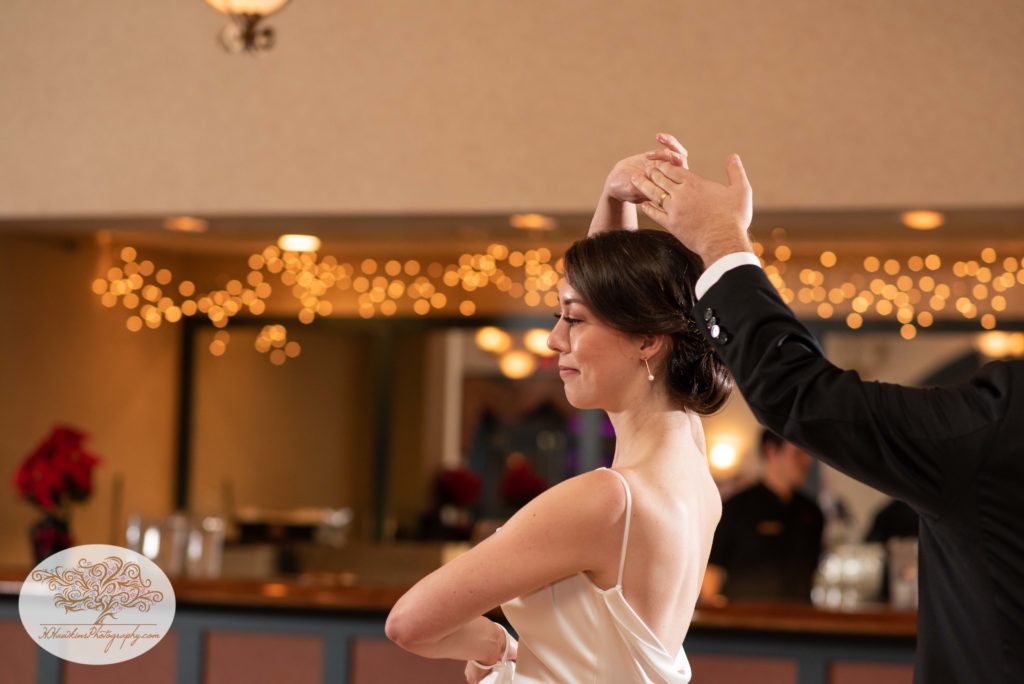 Bride spins across the dance floor with her groom