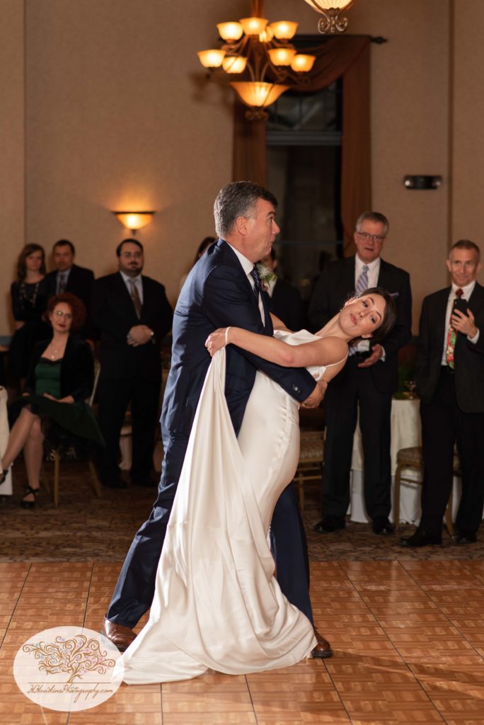 Father dips bride during their dance