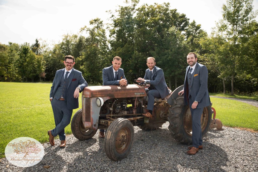 Groom and Groomsmen on old tractor at Hayloft on the Arch barn