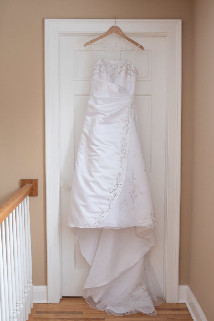 Wedding dress hanging on a door frame