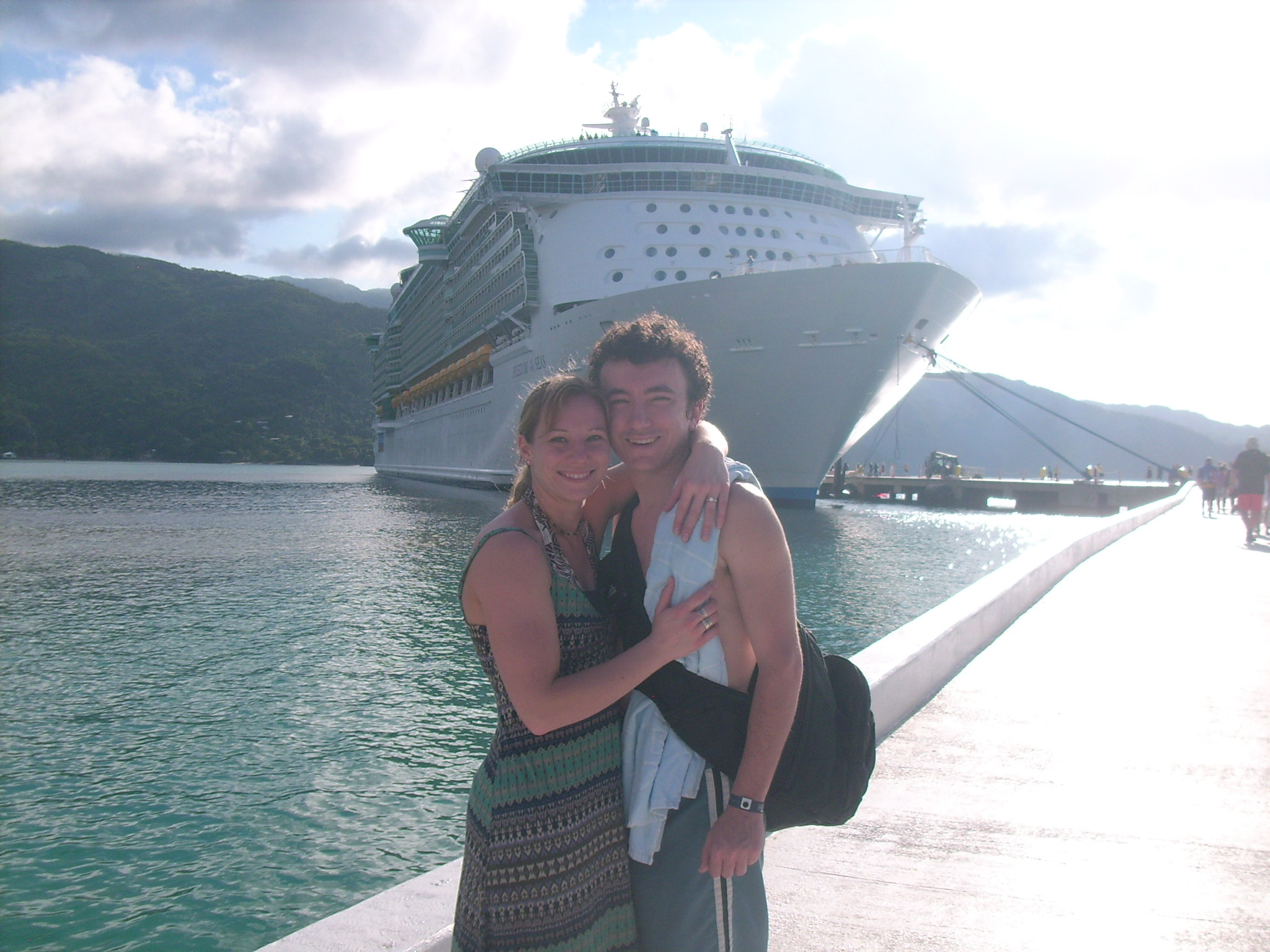 Newly engaged couple stands in front of Royal Caribbean's Freedom of the Seas in Labadee Haiti