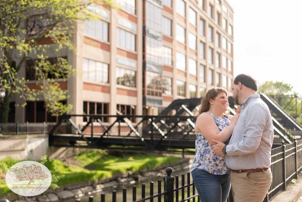 Bride and groom stand at the Creekwalk in Syracuse for their engagement pictures