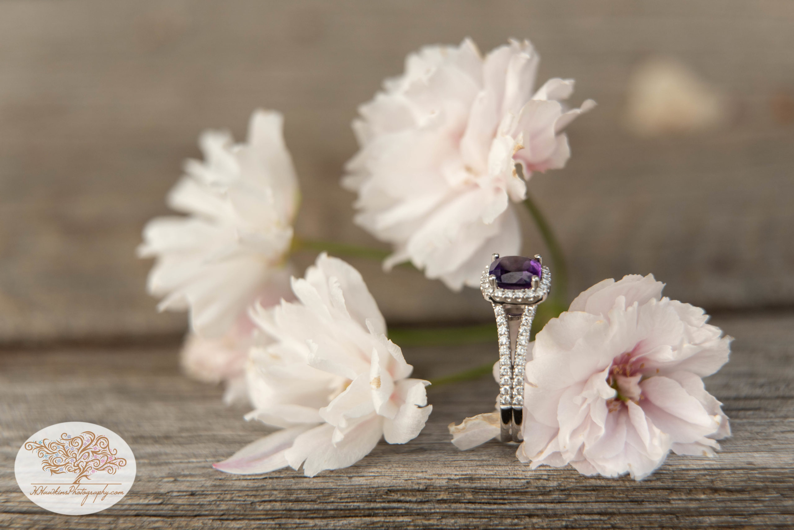Amethyst Engagement ring with white spring flowers around it