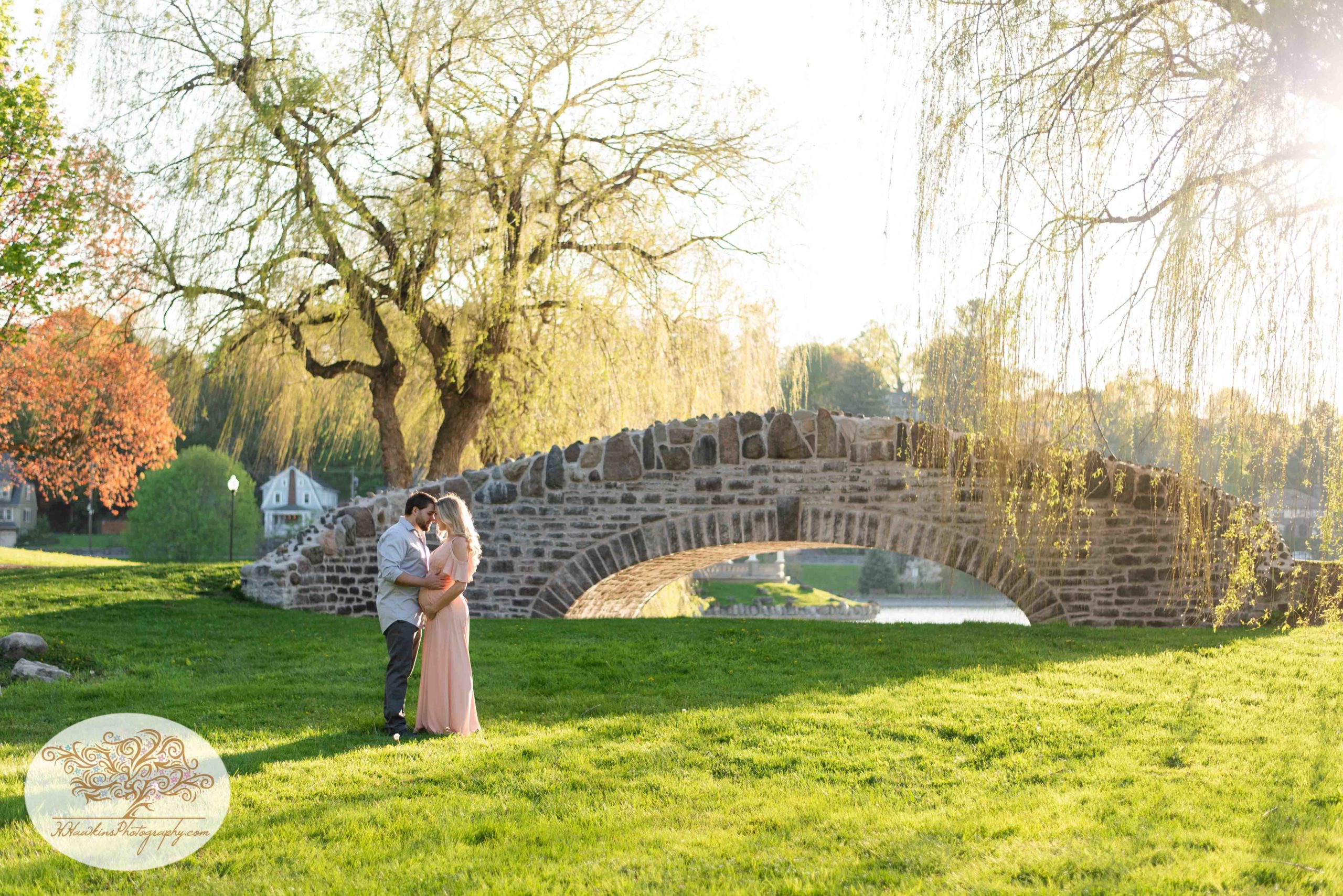 Syracuse maternity pictures at Upper Onondaga Park in front of stone bridge