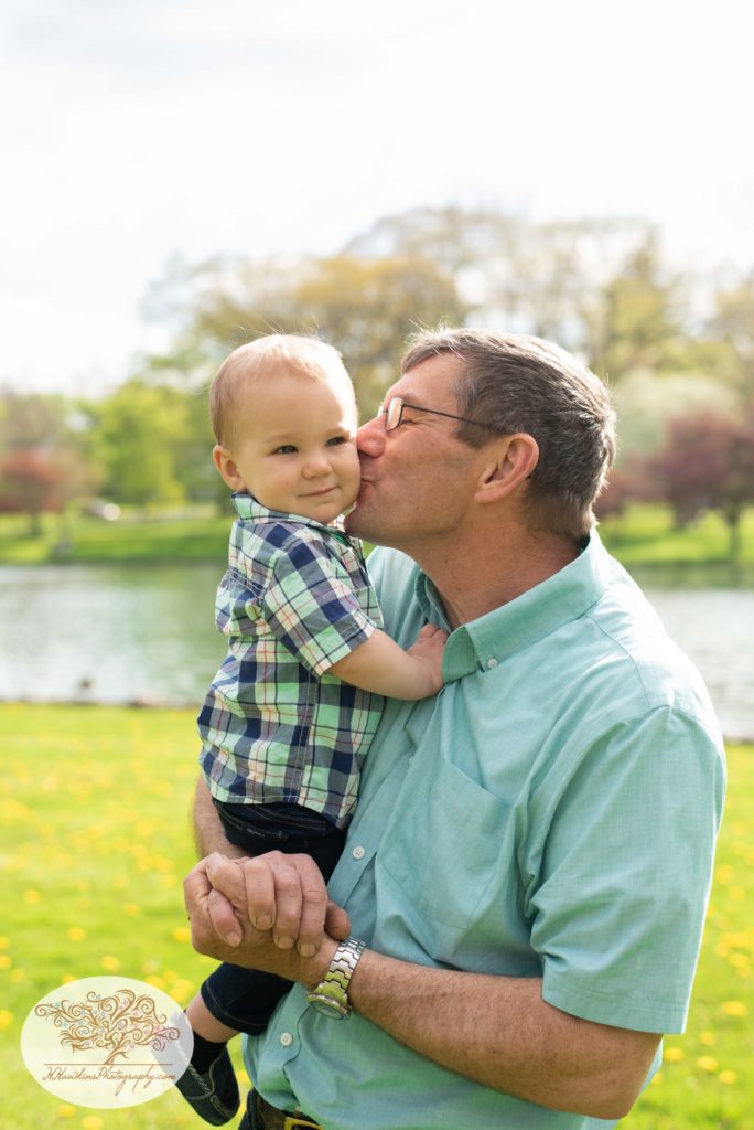 Grandpa kisses little boy on the cheek captured by syracuse family photographer