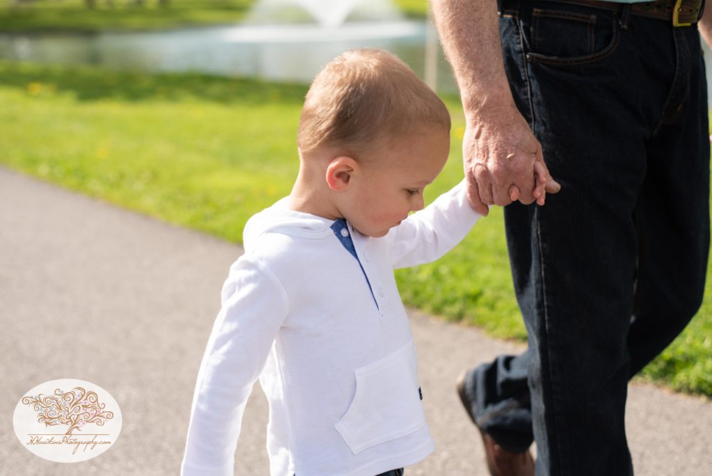 Little boy holds his grandpa's hand captured by syracuse family photographer