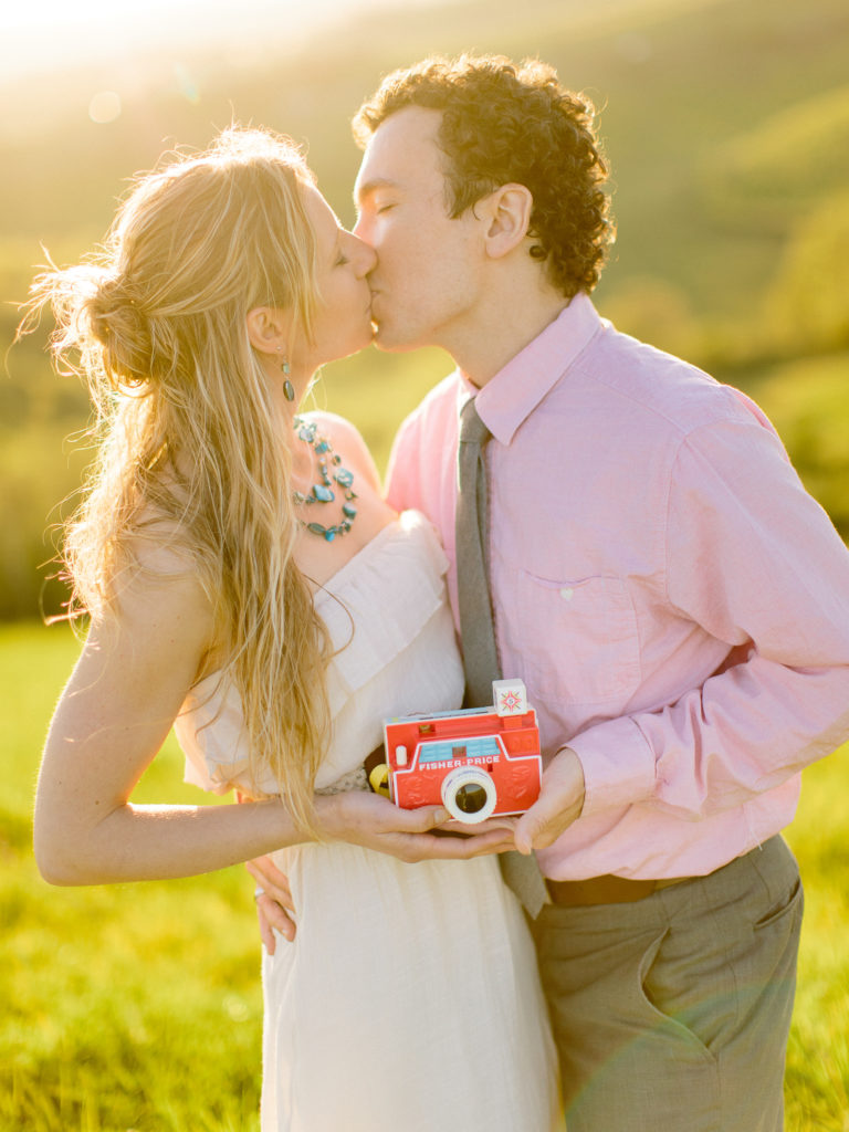 Syracuse wedding photographers share a kiss during pregnancy announcement that ended in miscarriage