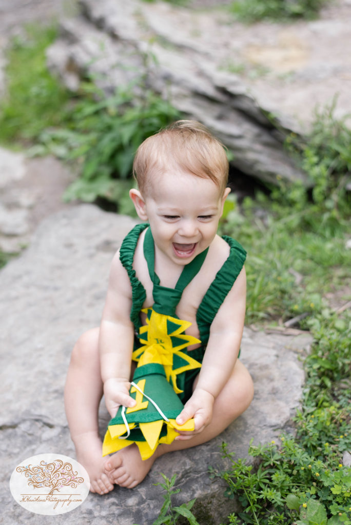 Little boy laughs during his one year old birthday pictures by Syracuse family photographer