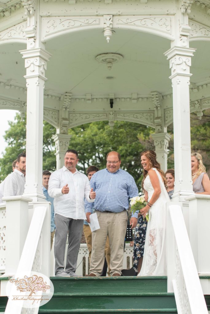 Groom gives a thumbs up during fingerlakes wedding ceremony in gazebo at Hoopes Park Auburn NY