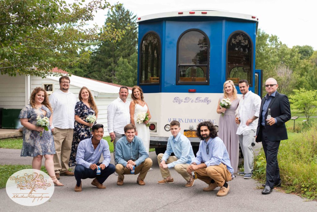 Bridal party stands in front of Big D's Limo trolley at Hoopes Park in Auburn NY by Fingerlakes Wedding photographer